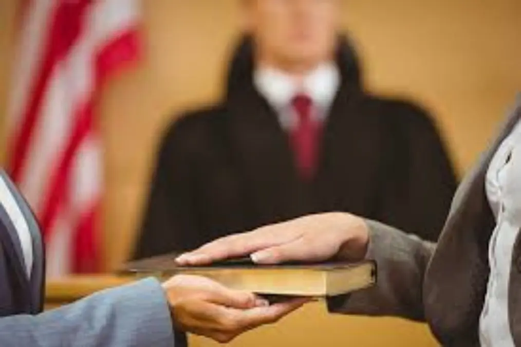 A judge is holding the bible in front of a man.